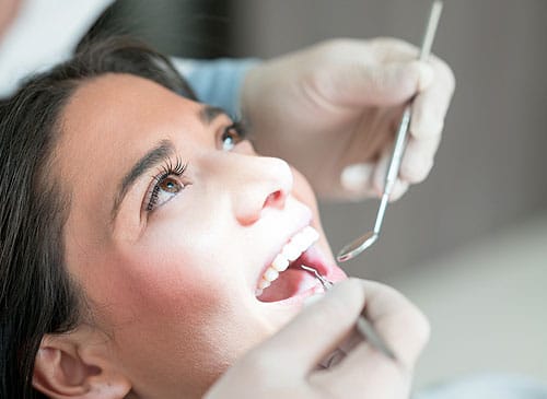A patient is in an office of a doctor for her restorative dentistry
